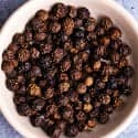 A plate of black peppercorns