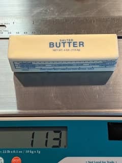 Image of butter on a scale weighing 113g