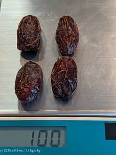 Four large medjool dates on a scale